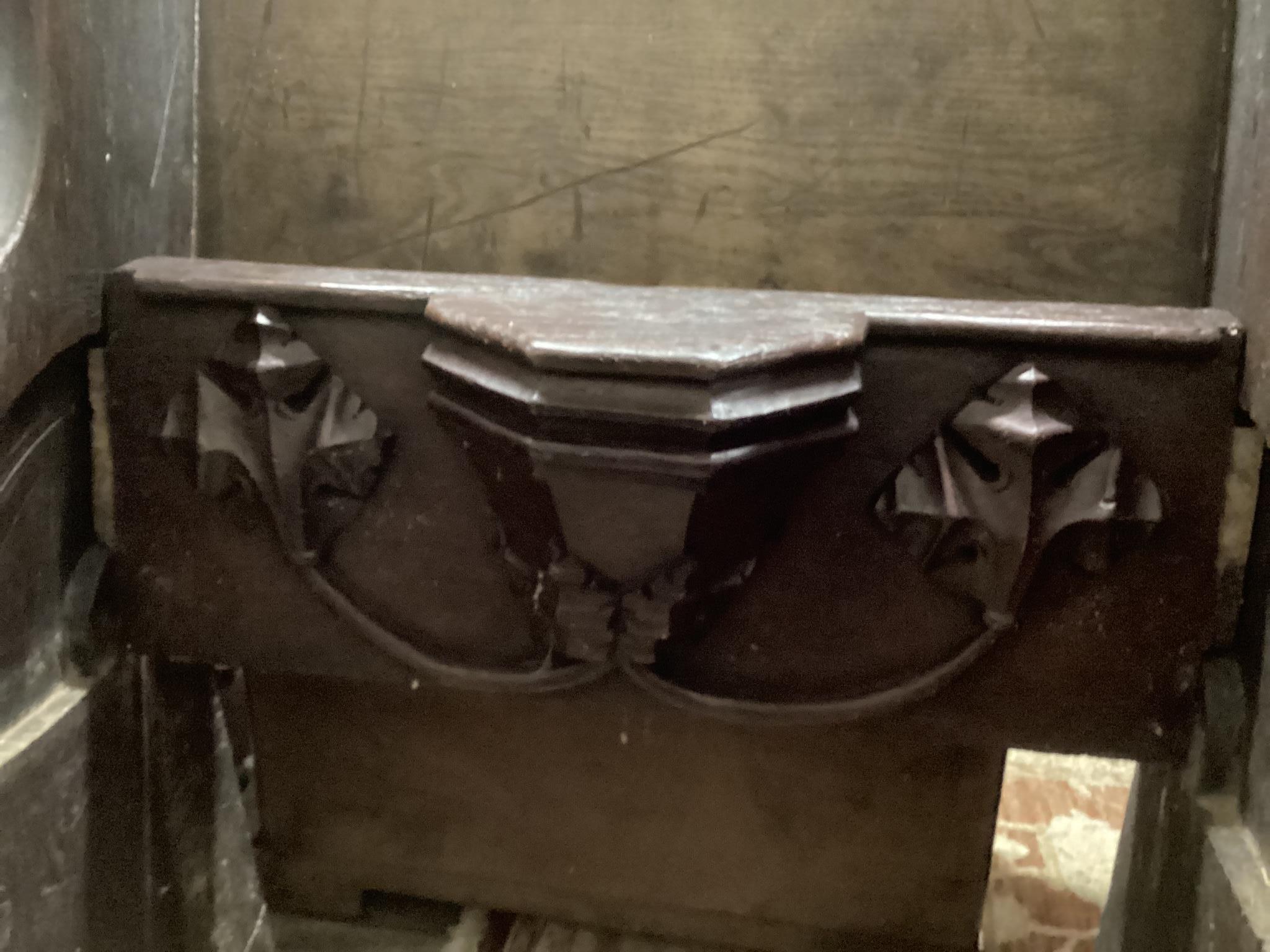 A 17th century and later oak pew with carved misericord, width 82cm, depth 40cm, height 109cm